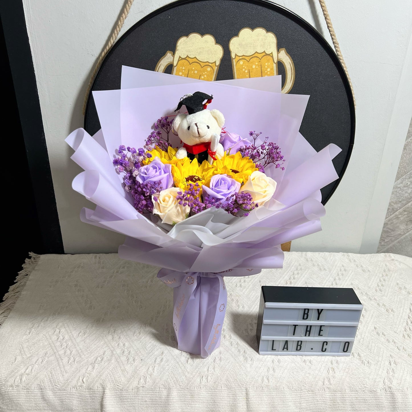 Graduation Bear with Soap Sunflower and Roses Bouquet - Purple